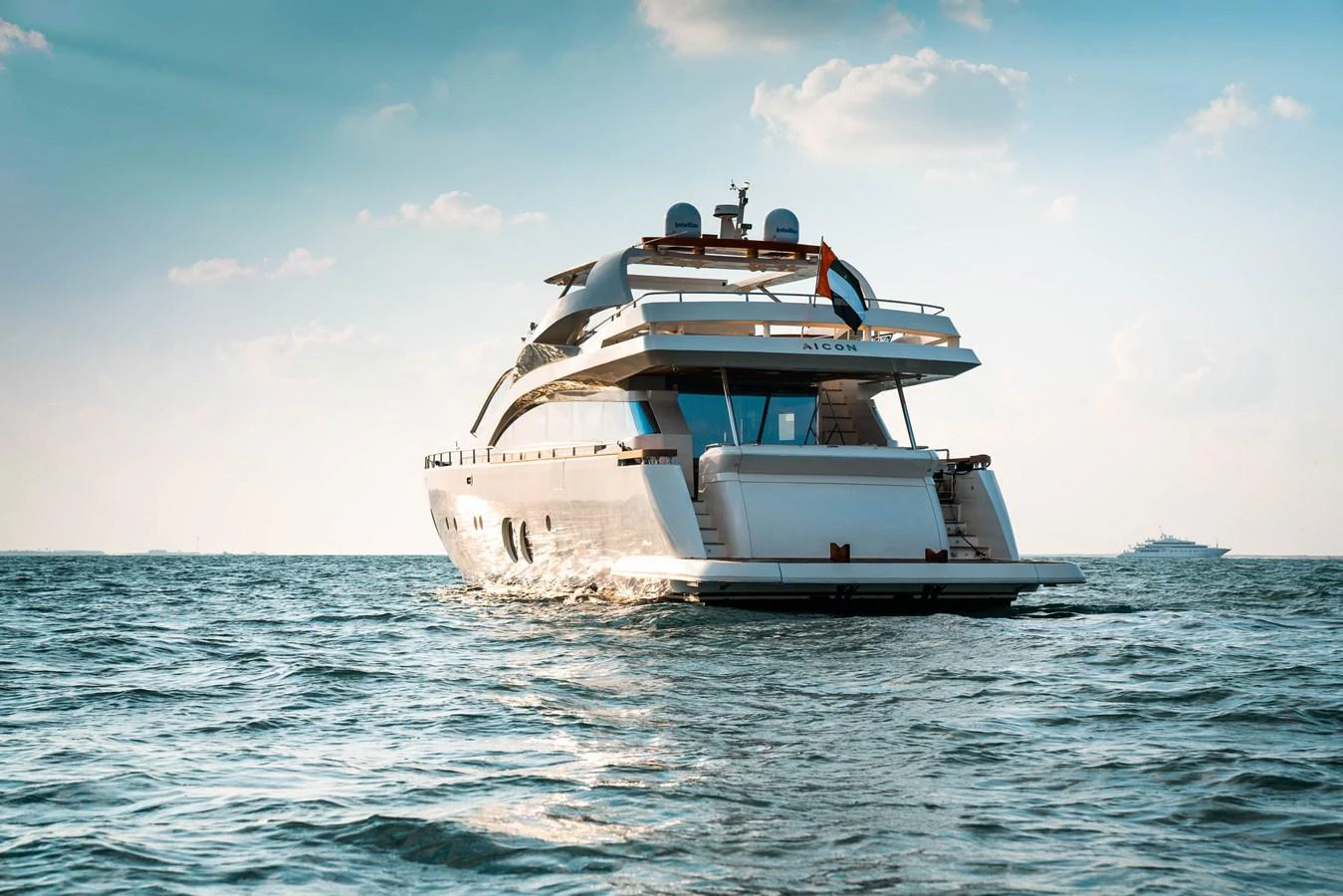 A luxurious yacht cruises gracefully on calm waters under a clear sky. aboard TAYGET Yacht for Sale