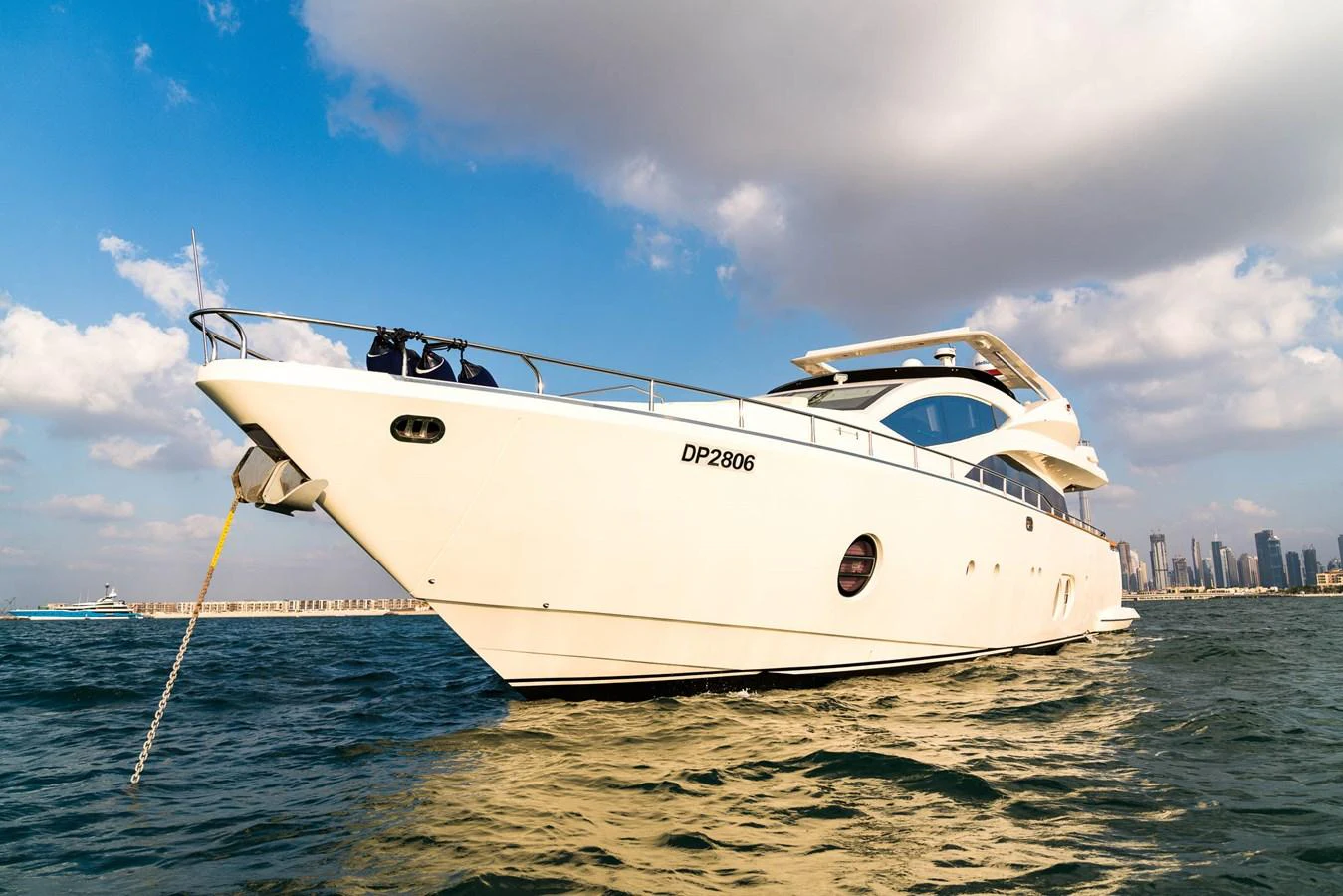 A sleek and modern yacht glides gracefully on the water under a partly cloudy sky. aboard TAYGET Yacht for Sale