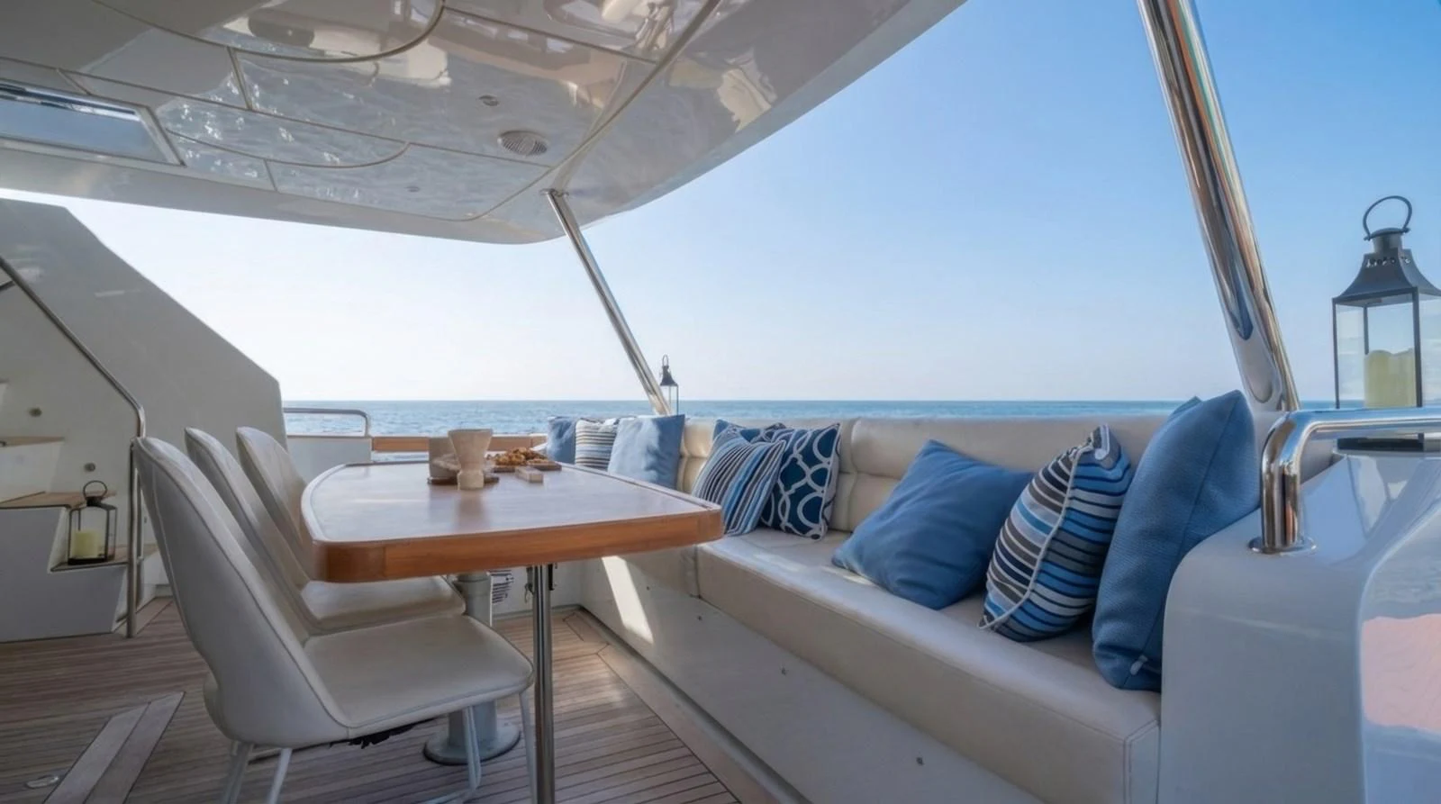 The aft deck offers a serene dining area with comfortable seating and a stunning ocean view. aboard TAYGET Yacht for Sale