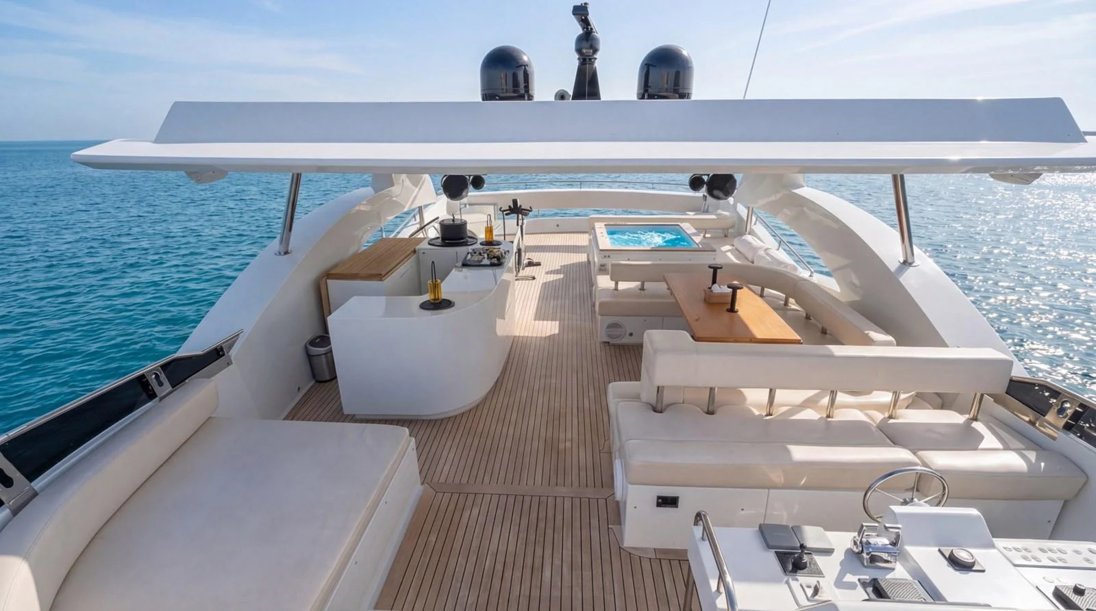 The flybridge offers a spacious and luxurious outdoor living area with ample seating and a stunning view of the sea. aboard TAYGET Yacht for Sale