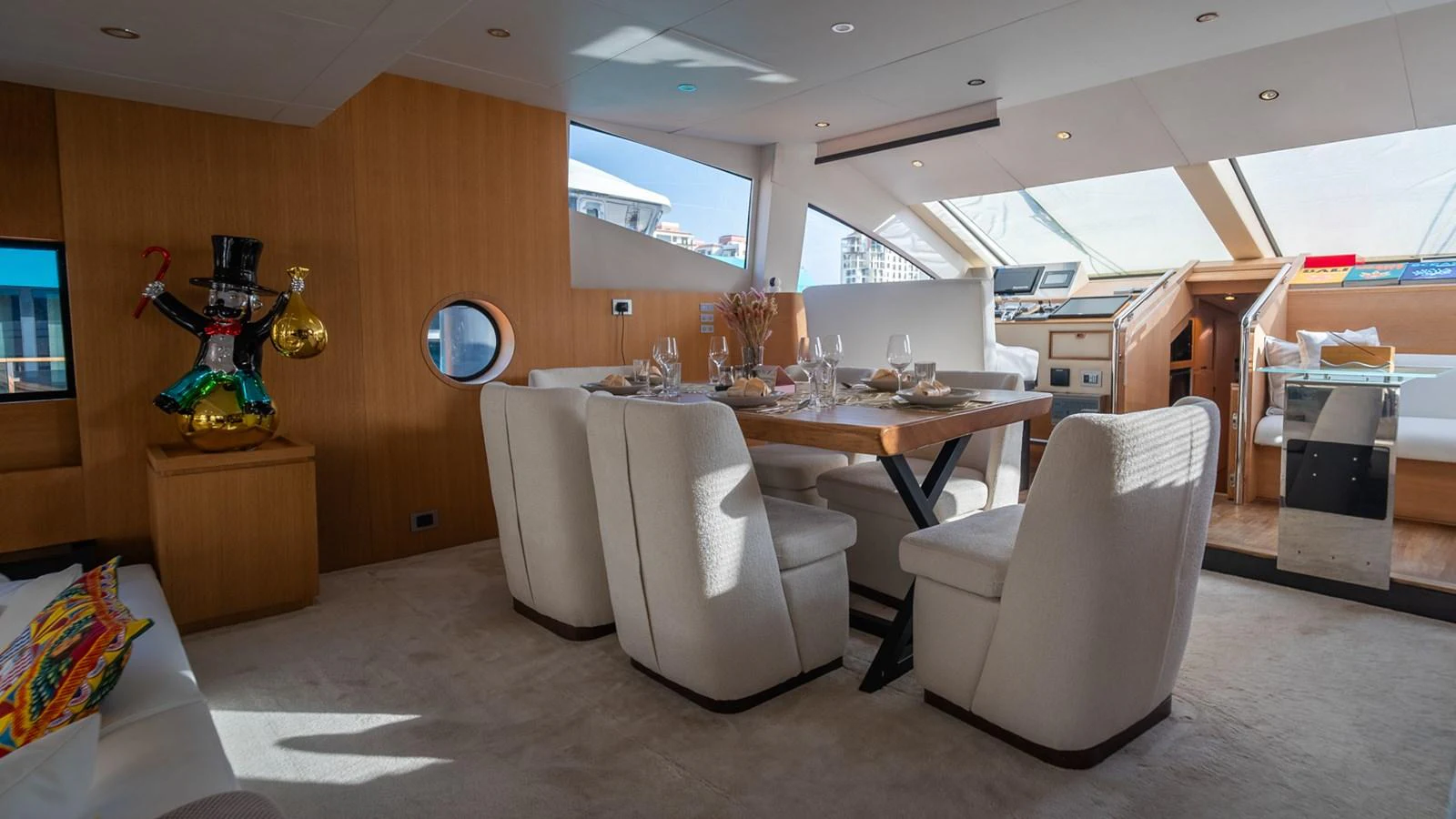 The yacht's dining area features a stylish table with plush seating and ample natural light. aboard TAYGET Yacht for Sale