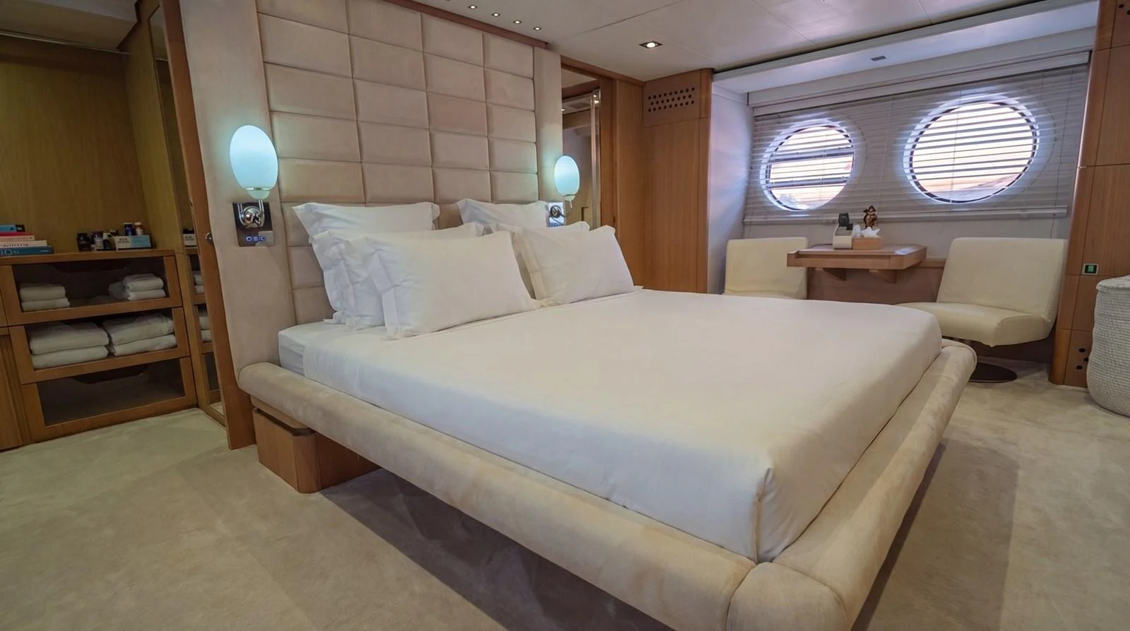 The master stateroom features a luxurious bed with elegant lighting and ample storage. aboard TAYGET Yacht for Sale
