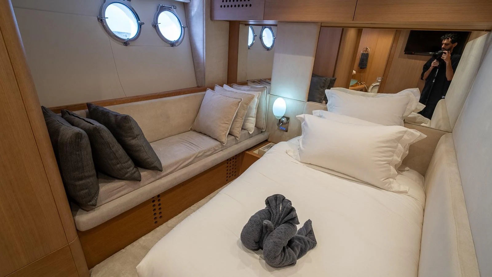 The guest stateroom features a cozy bed, a comfortable seating area, and elegant decor. aboard TAYGET Yacht for Sale