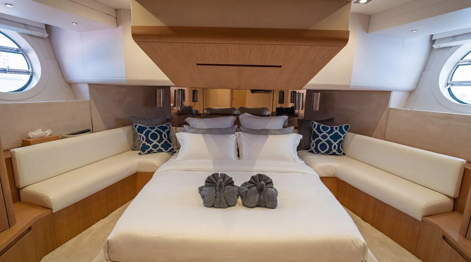 The master stateroom features a luxurious bed with elegant linens and ample seating. aboard TAYGET Yacht for Sale