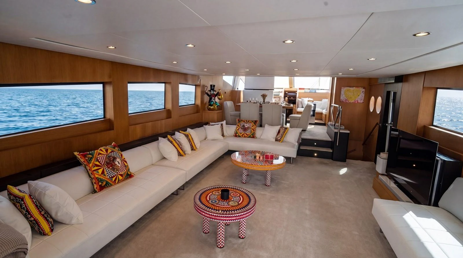 The spacious salon features modern furnishings and expansive windows with a stunning sea view. aboard TAYGET Yacht for Sale