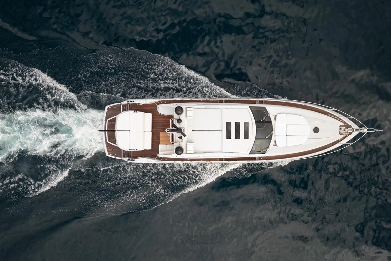 An aerial view of a sleek yacht cruising through the water. aboard M/Y TITAN Yacht for Sale