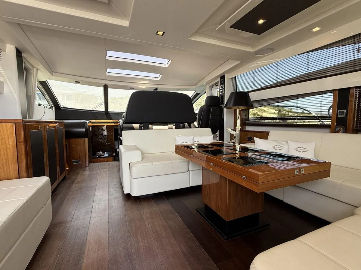 The yacht's salon features luxurious seating and a sophisticated design with ample natural light. aboard M/Y TITAN Yacht for Sale