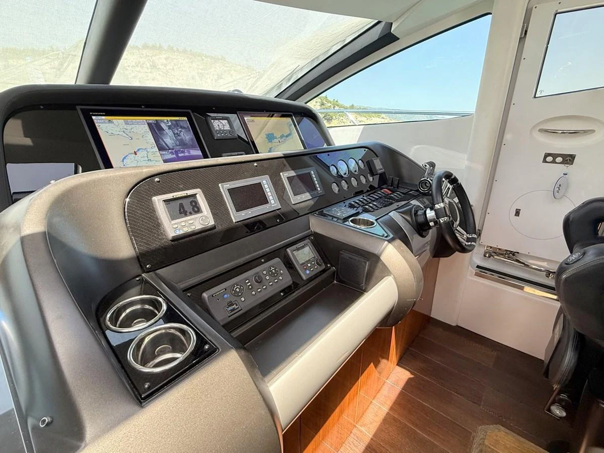 The helm station features advanced navigation equipment and a sleek, modern design. aboard M/Y TITAN Yacht for Sale