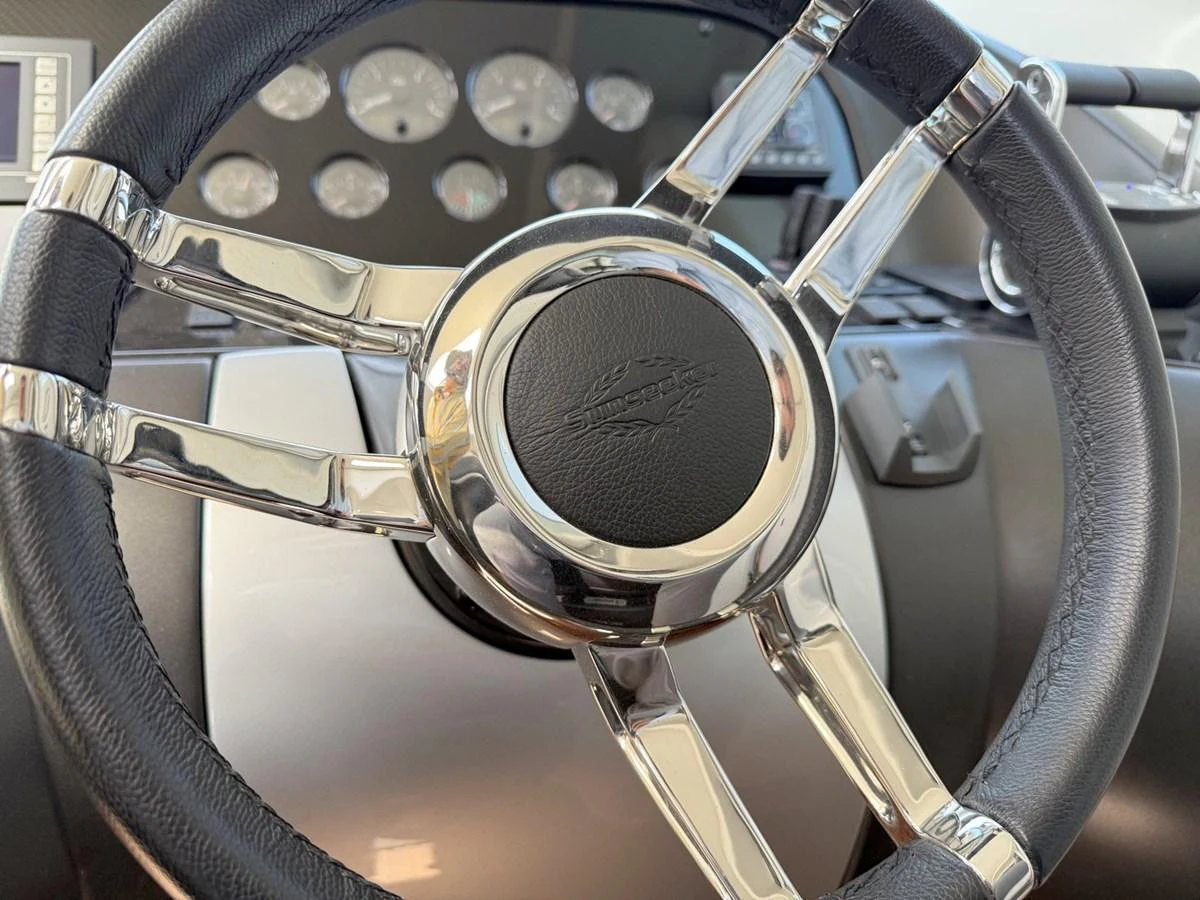 A close-up view of the yacht's steering wheel and dashboard instruments. aboard M/Y TITAN Yacht for Sale