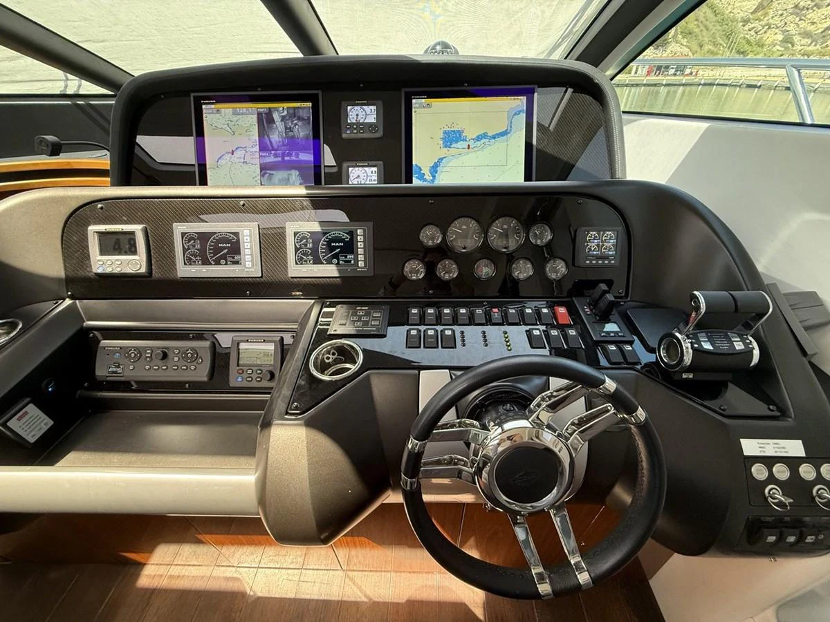 The helm station features advanced navigation equipment and a sleek steering wheel. aboard M/Y TITAN Yacht for Sale