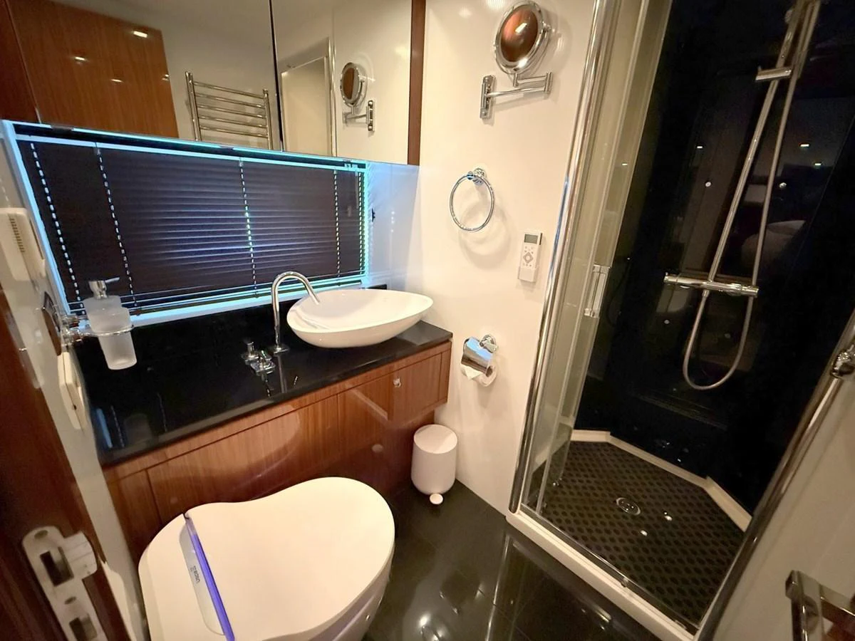 The yacht's bathroom features modern fixtures and a sleek design, providing a luxurious and comfortable space. aboard M/Y TITAN Yacht for Sale