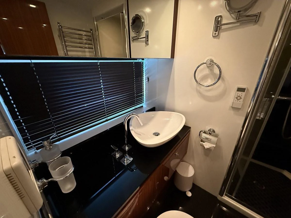 A modern yacht bathroom featuring sleek fixtures and a stylish design. aboard M/Y TITAN Yacht for Sale