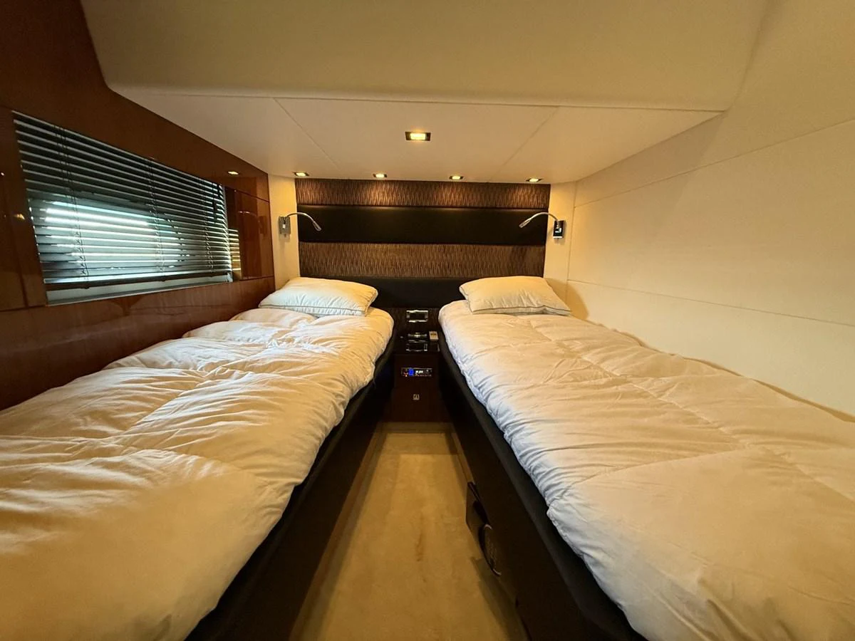 The twin stateroom offers a cozy and comfortable sleeping arrangement with two single beds. aboard M/Y TITAN Yacht for Sale