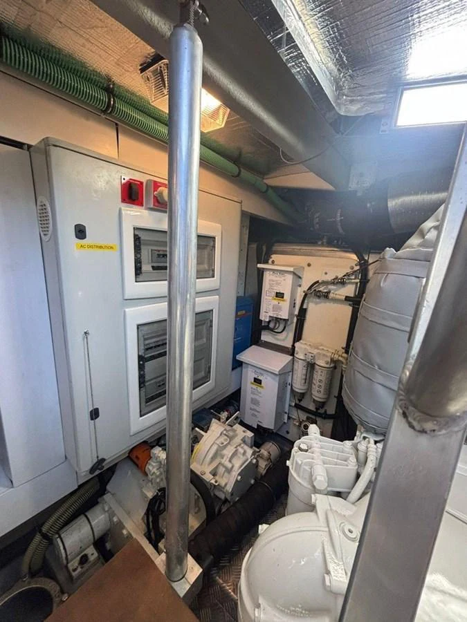 The image showcases the yacht's well-organized engine room with various technical equipment and machinery. aboard M/Y TITAN Yacht for Sale