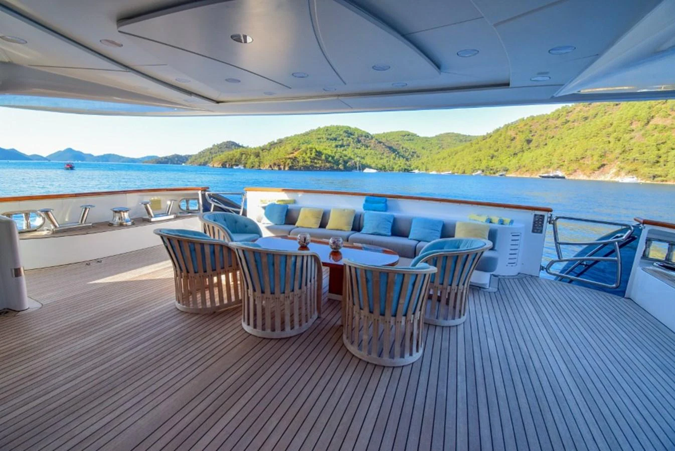 The aft deck features a spacious seating area with a stunning view of the surrounding waters and lush greenery. aboard HOLIDAY Yacht for Sale