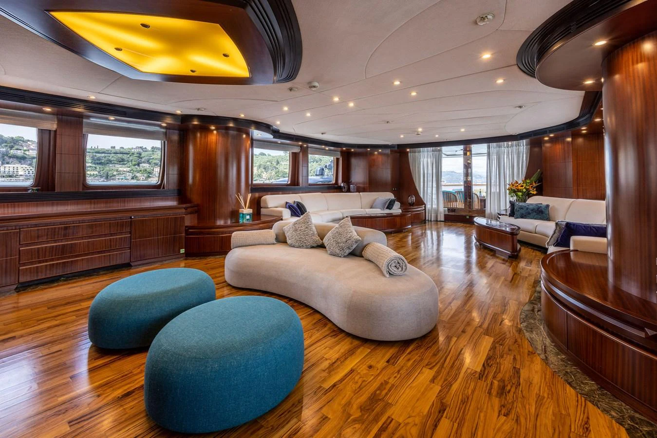 The spacious salon features elegant wood finishes, plush seating, and panoramic windows offering stunning views. aboard HOLIDAY Yacht for Sale