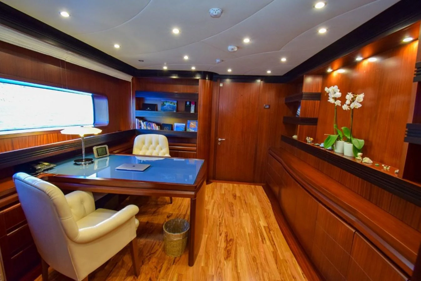 The yacht's office features elegant wood paneling, a large desk, and comfortable seating, creating a sophisticated workspace. aboard HOLIDAY Yacht for Sale