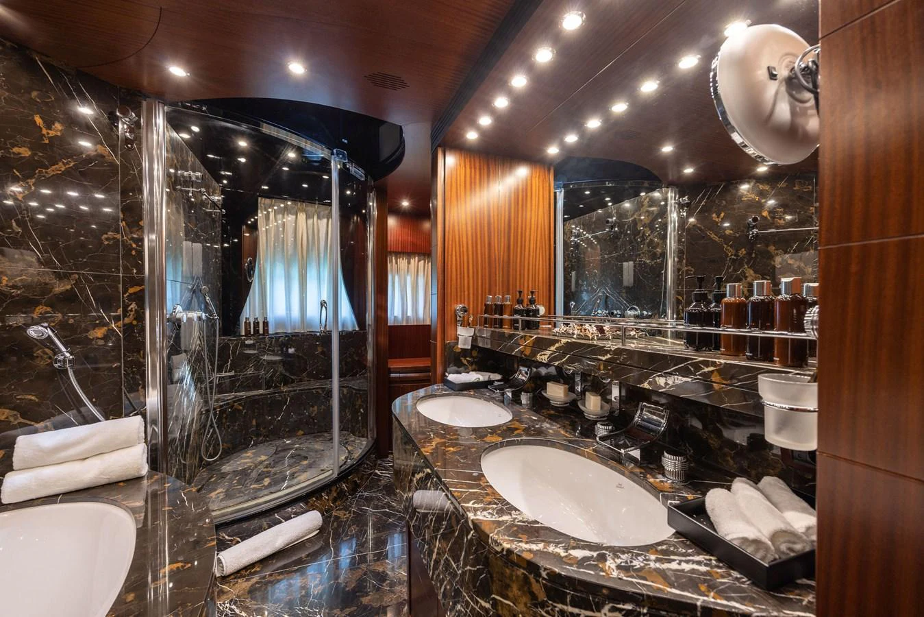 The luxurious bathroom features elegant marble surfaces and modern fixtures. aboard HOLIDAY Yacht for Sale