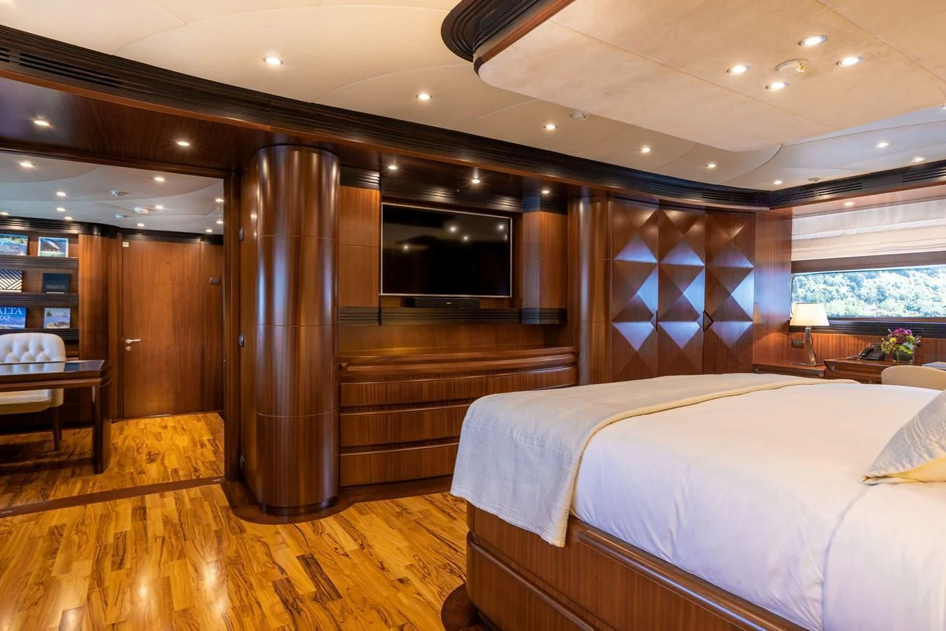 The master stateroom features elegant wood paneling and luxurious bedding. aboard HOLIDAY Yacht for Sale