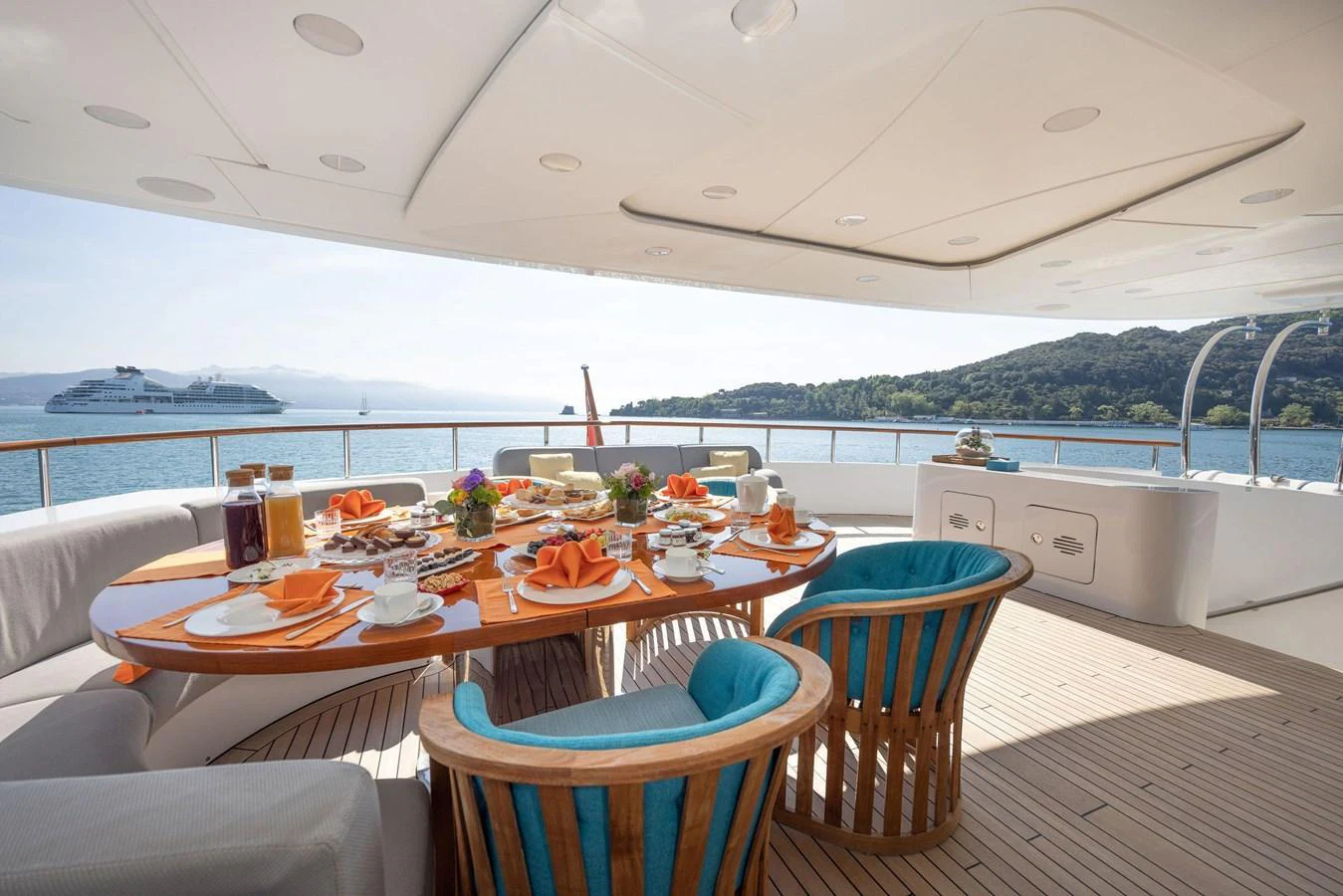 The aft deck features an elegant dining area with a stunning view of the sea. aboard HOLIDAY Yacht for Sale