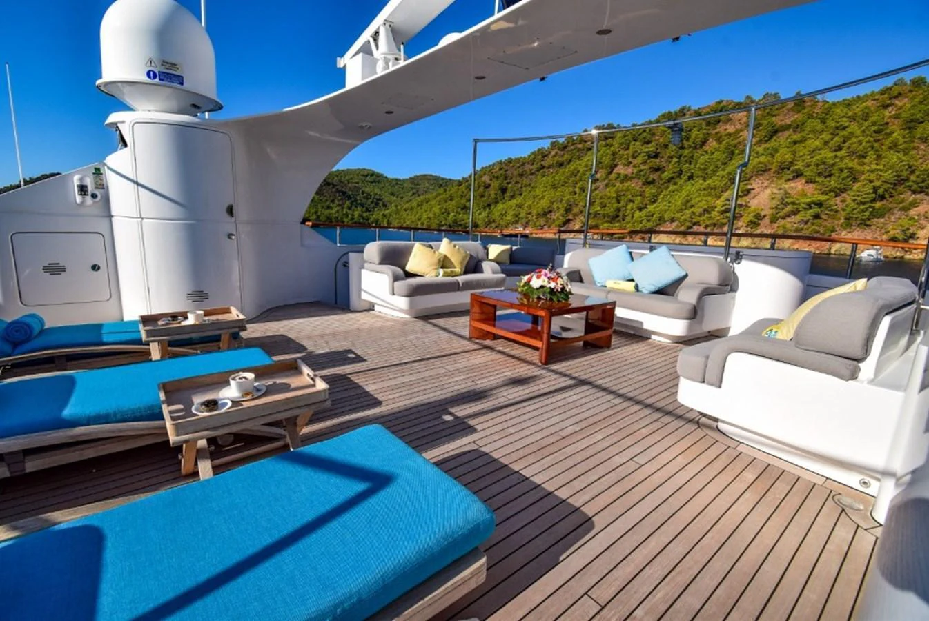 The sundeck offers a spacious lounging area with comfortable seating and stunning views. aboard HOLIDAY Yacht for Sale