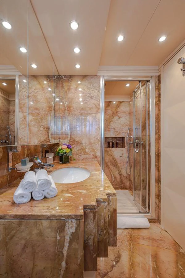 The luxurious bathroom features elegant marble surfaces and modern fixtures. aboard HOLIDAY Yacht for Sale