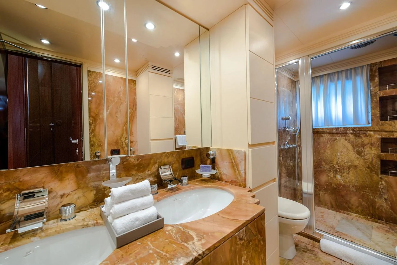 The yacht's bathroom features luxurious marble surfaces and modern amenities. aboard HOLIDAY Yacht for Sale