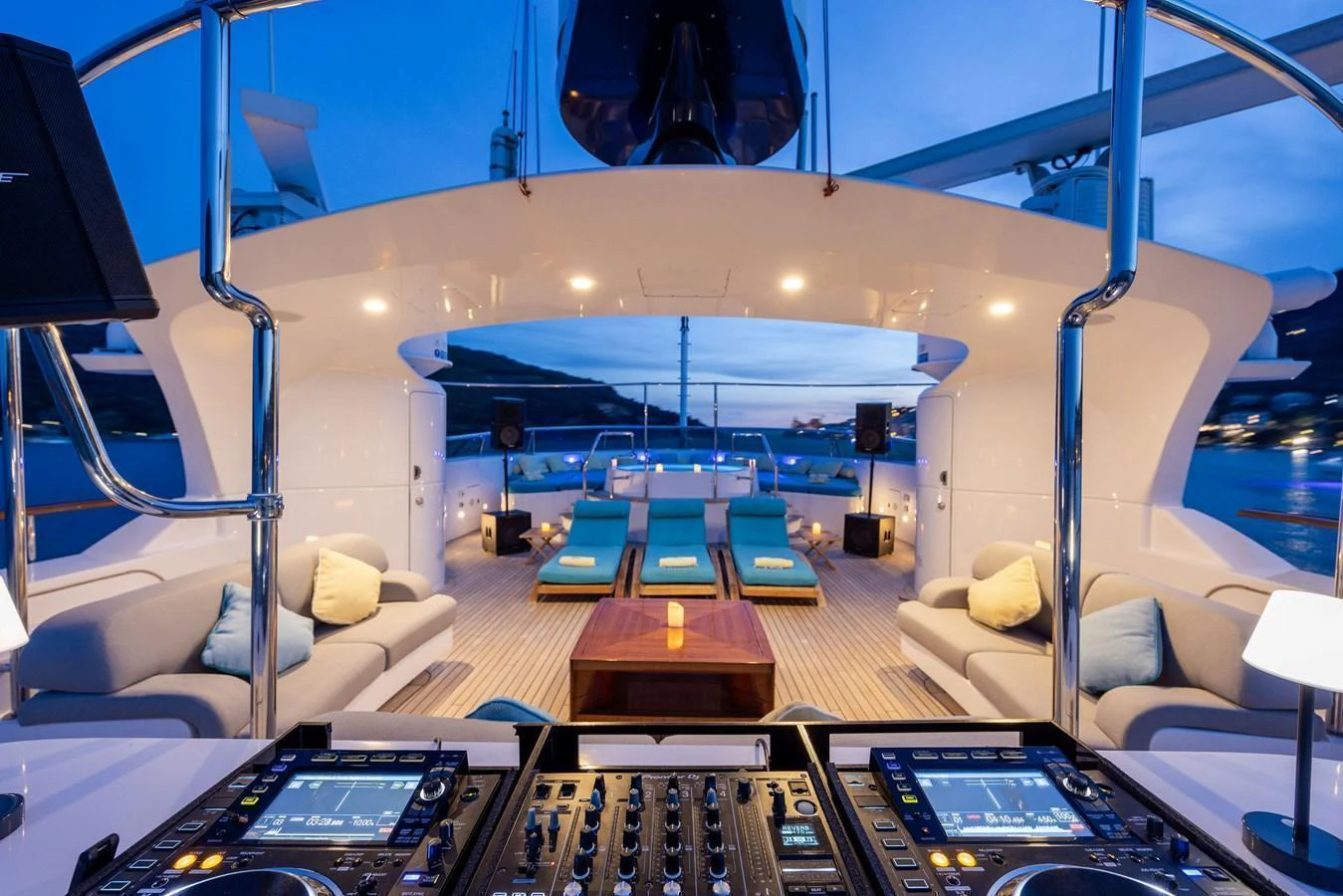 The sundeck features a luxurious lounging area with a DJ setup for entertainment. aboard HOLIDAY Yacht for Sale
