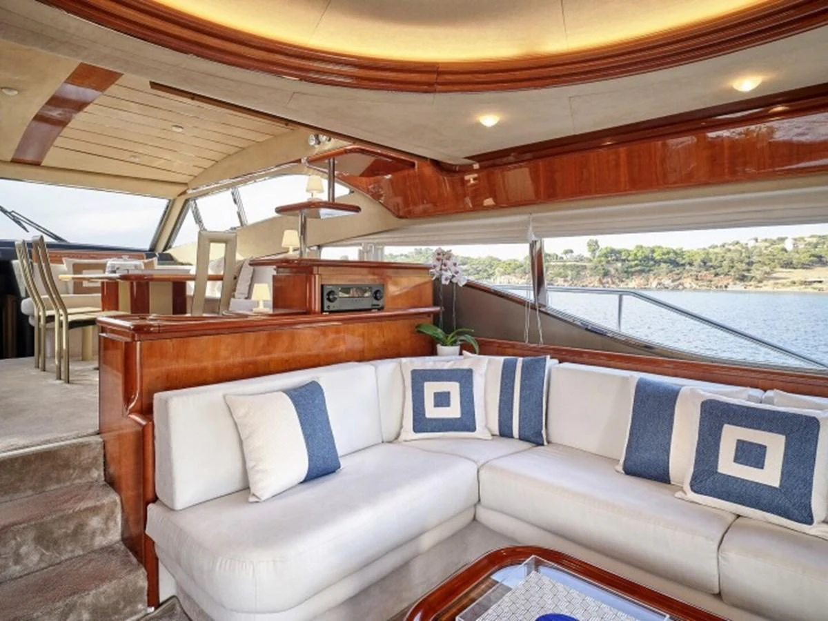 a living room with a couch and a window aboard MIREN Yacht for Sale
