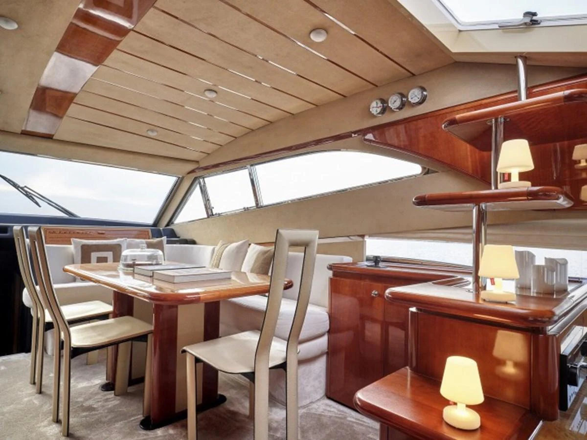 a restaurant with a table and chairs aboard MIREN Yacht for Sale