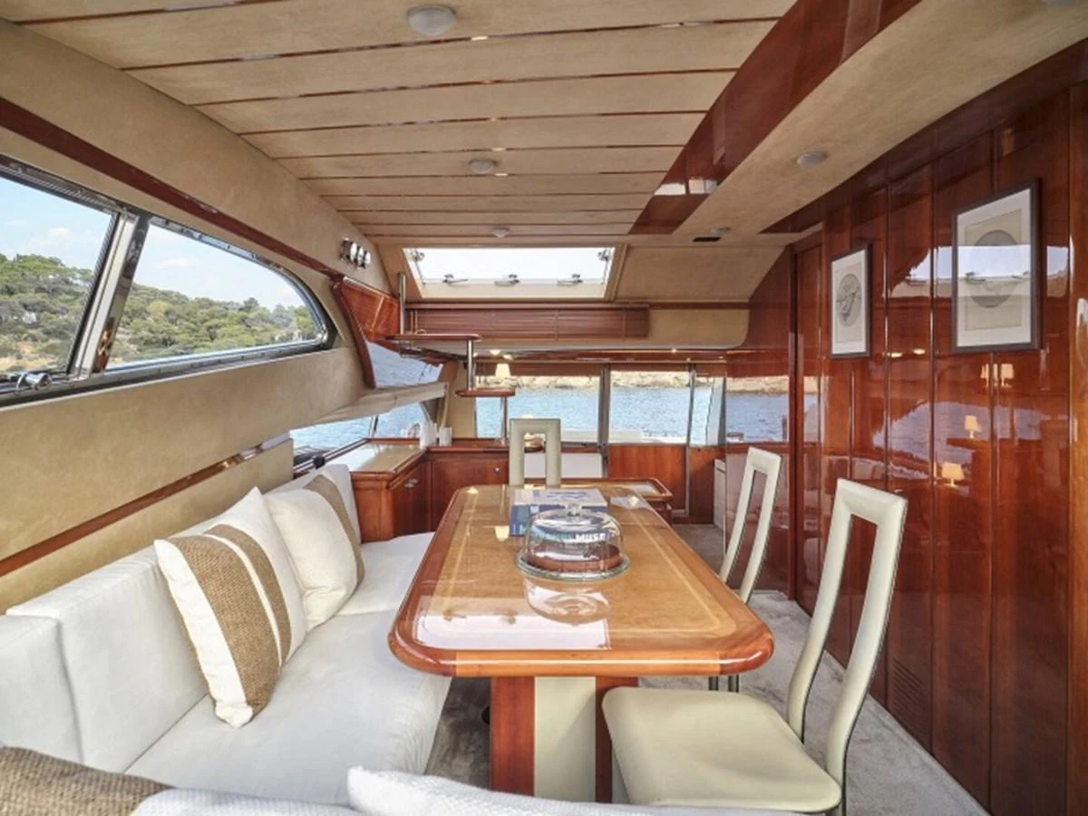 a train car with a table and chairs aboard MIREN Yacht for Sale