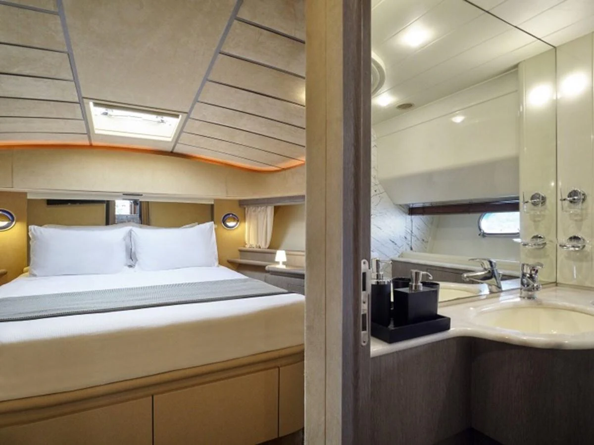 a bathroom with a sink and a bed aboard MIREN Yacht for Sale