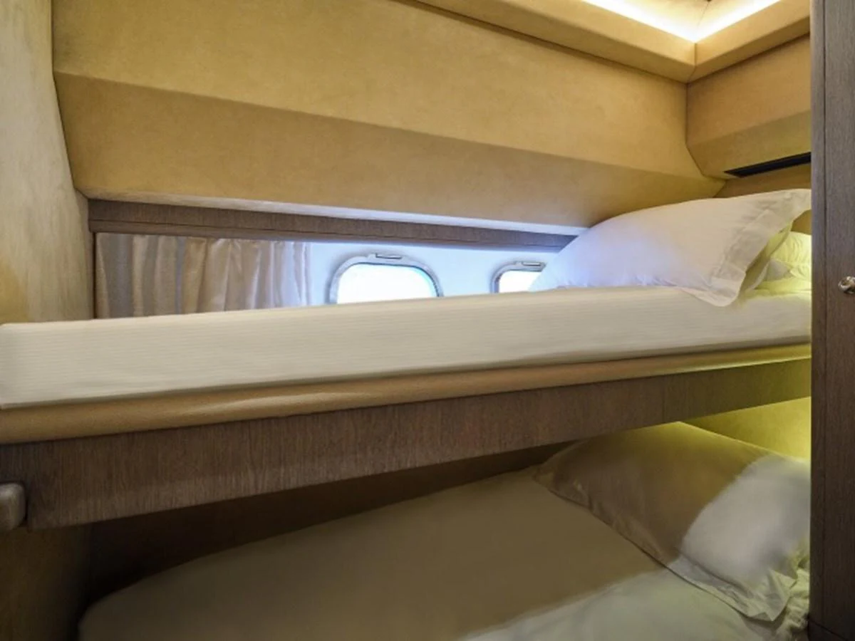 a bed with a white bed sheet aboard MIREN Yacht for Sale