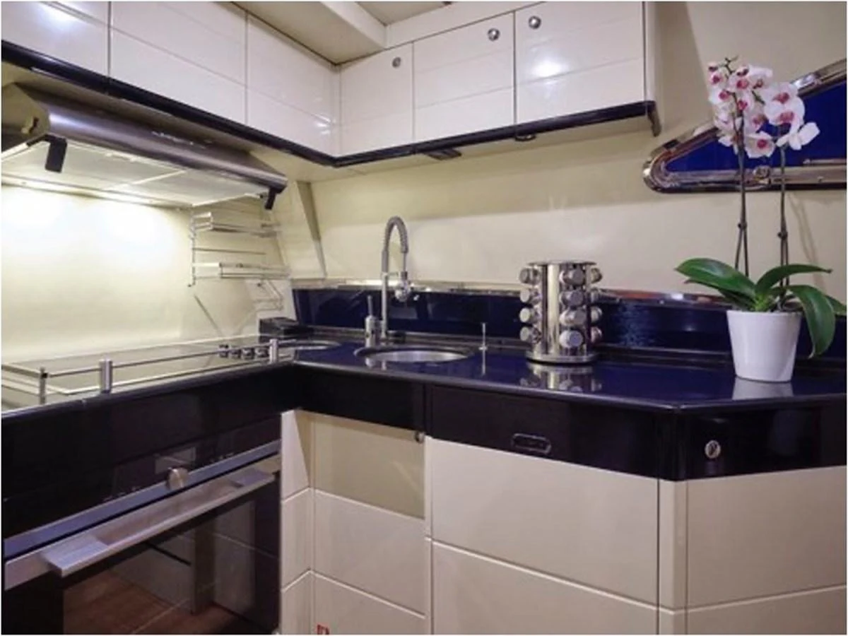 a kitchen with white cabinets aboard MIREN Yacht for Sale