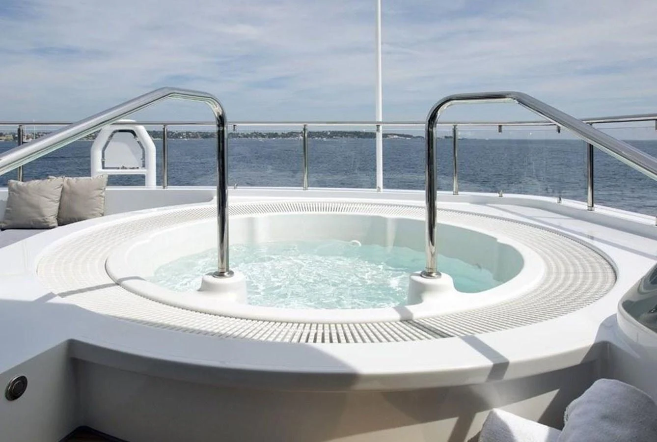 The yacht features a luxurious jacuzzi with stunning ocean views. aboard PRINCESS TOO Yacht for Sale