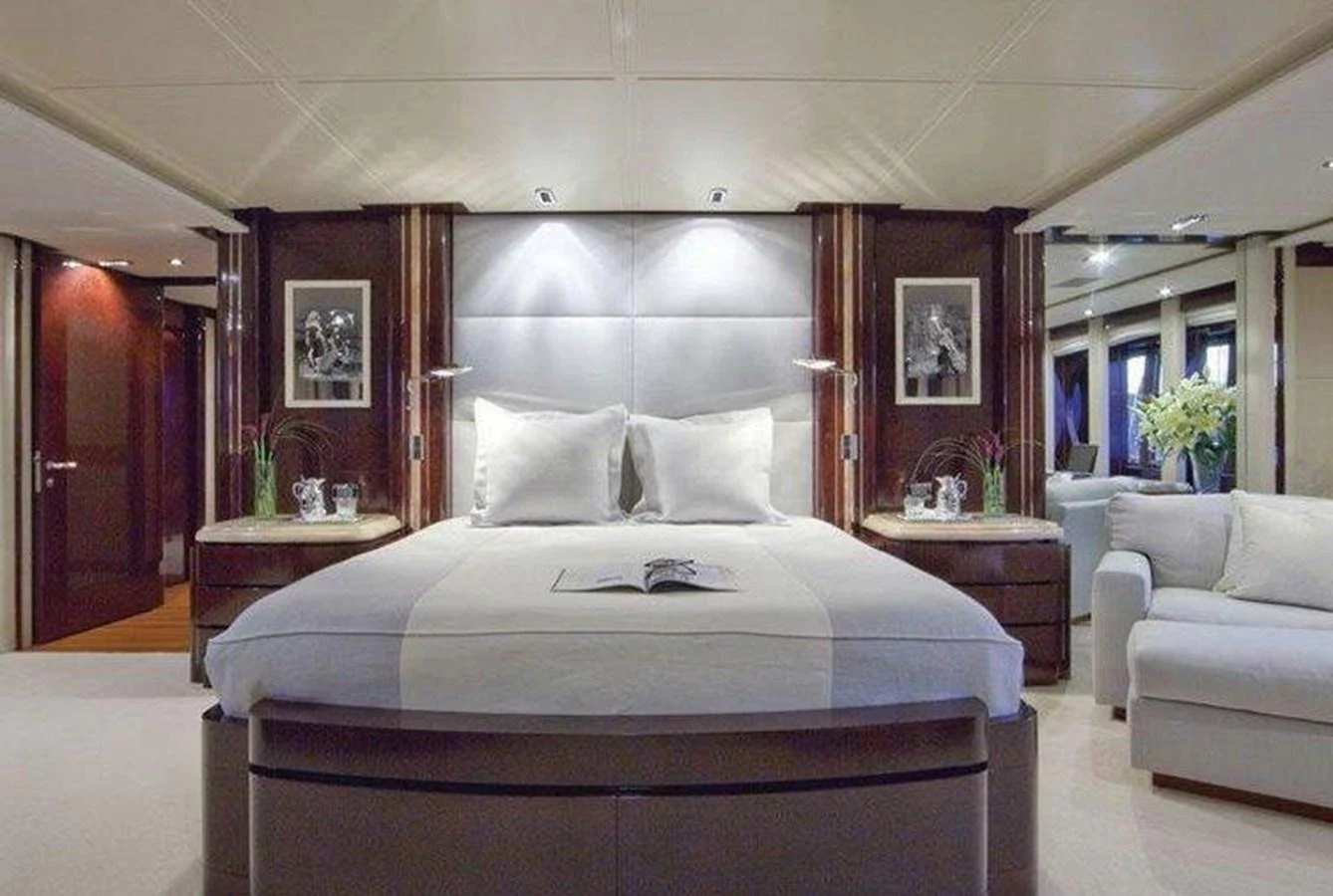 The master stateroom features a luxurious bed with elegant decor and ample lighting. aboard PRINCESS TOO Yacht for Sale