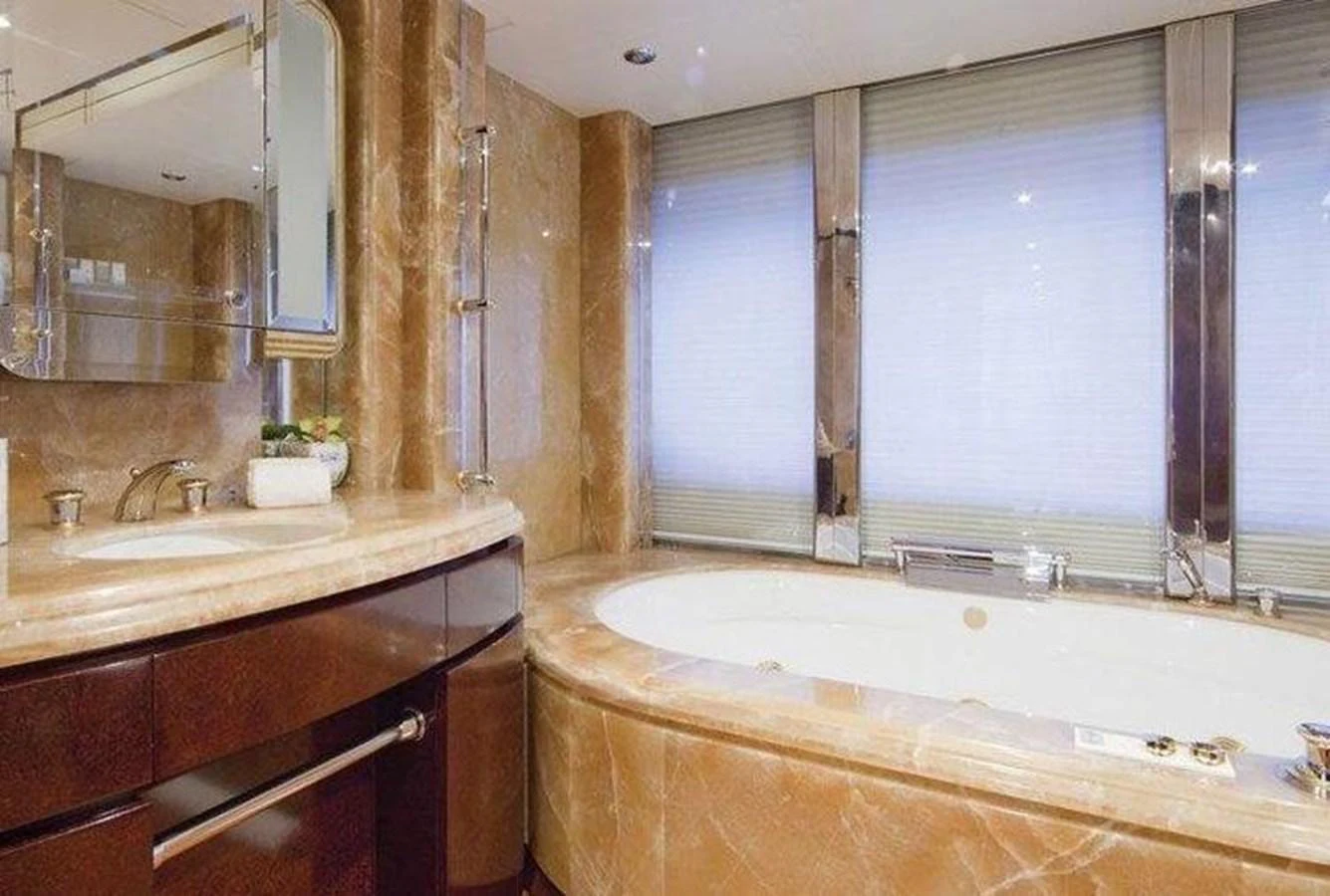 The yacht's bathroom features luxurious marble finishes and a spacious bathtub. aboard PRINCESS TOO Yacht for Sale