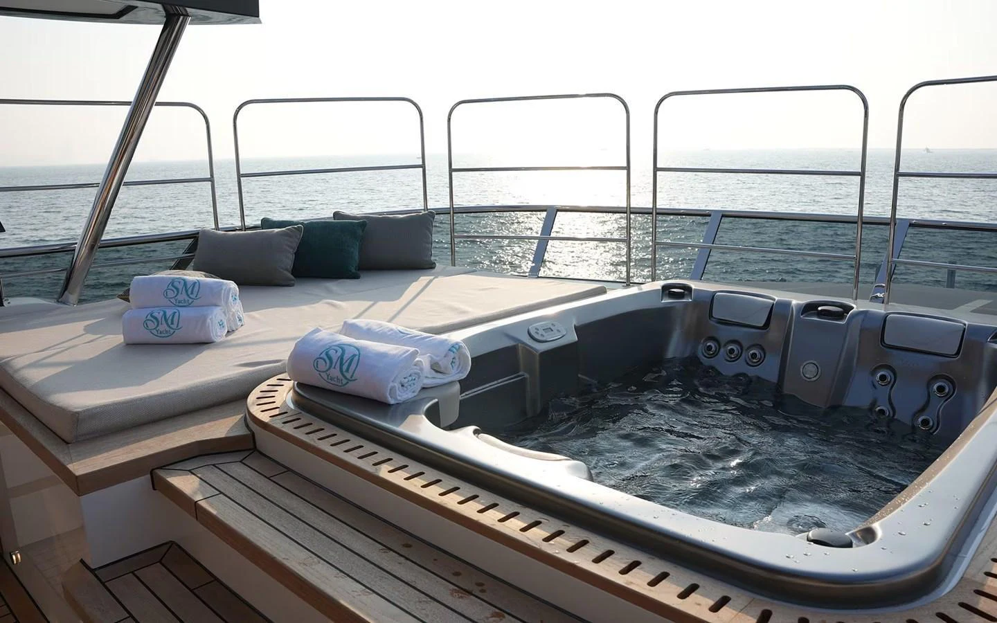 The sundeck features a luxurious hot tub with plush seating and towels, offering a perfect spot for relaxation while enjoying the ocean view. aboard GEULUNEL Yacht for Sale
