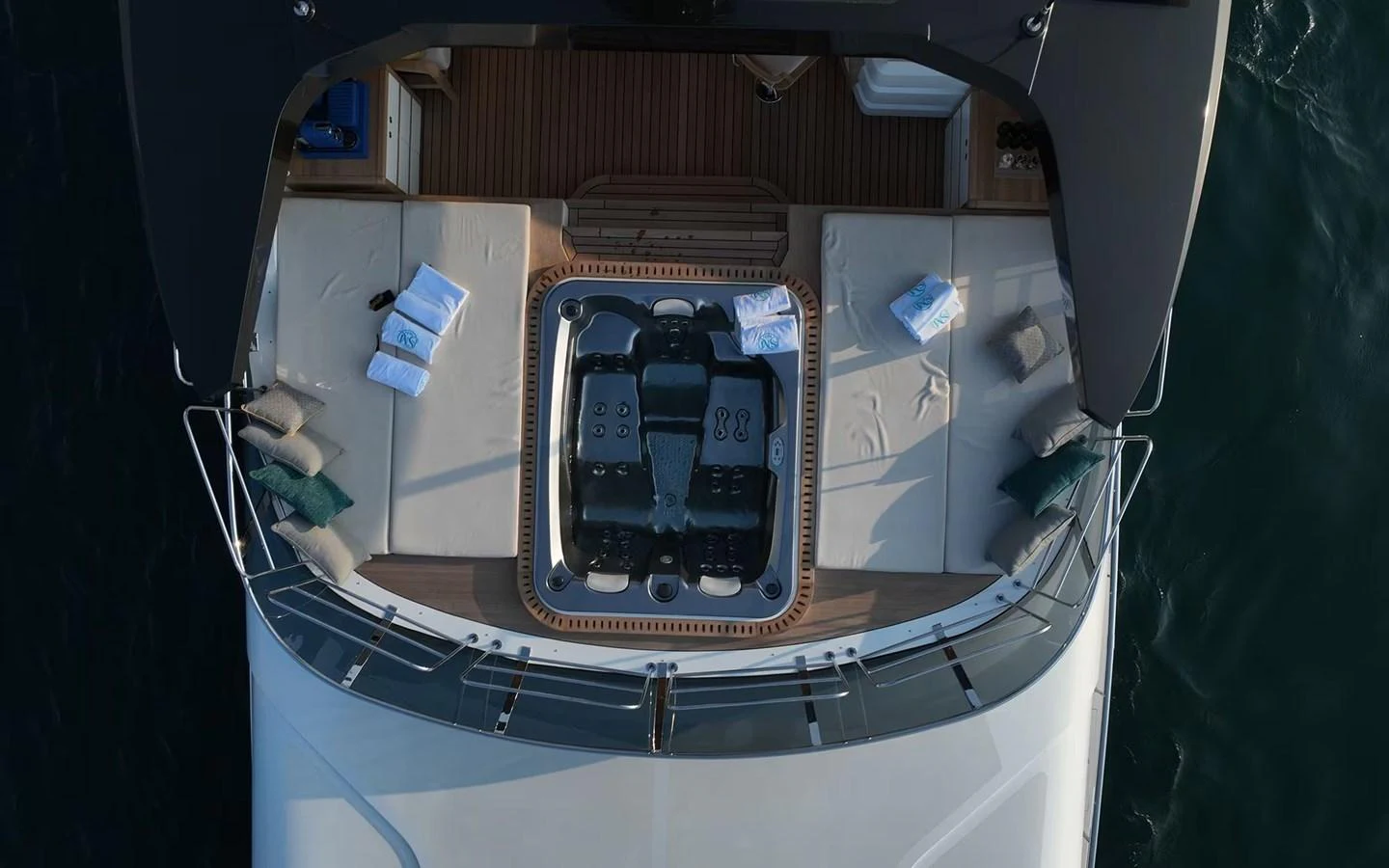 The aft deck features a luxurious lounging area with plush seating and a central table, perfect for relaxation and socializing. aboard GEULUNEL Yacht for Sale