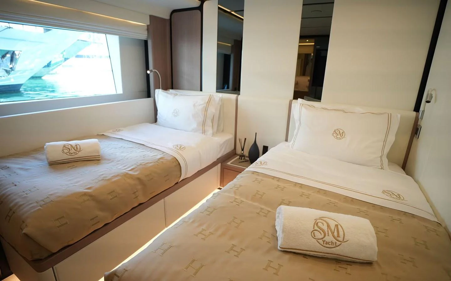The guest stateroom features twin beds with luxurious linens and a serene ambiance. aboard GEULUNEL Yacht for Sale