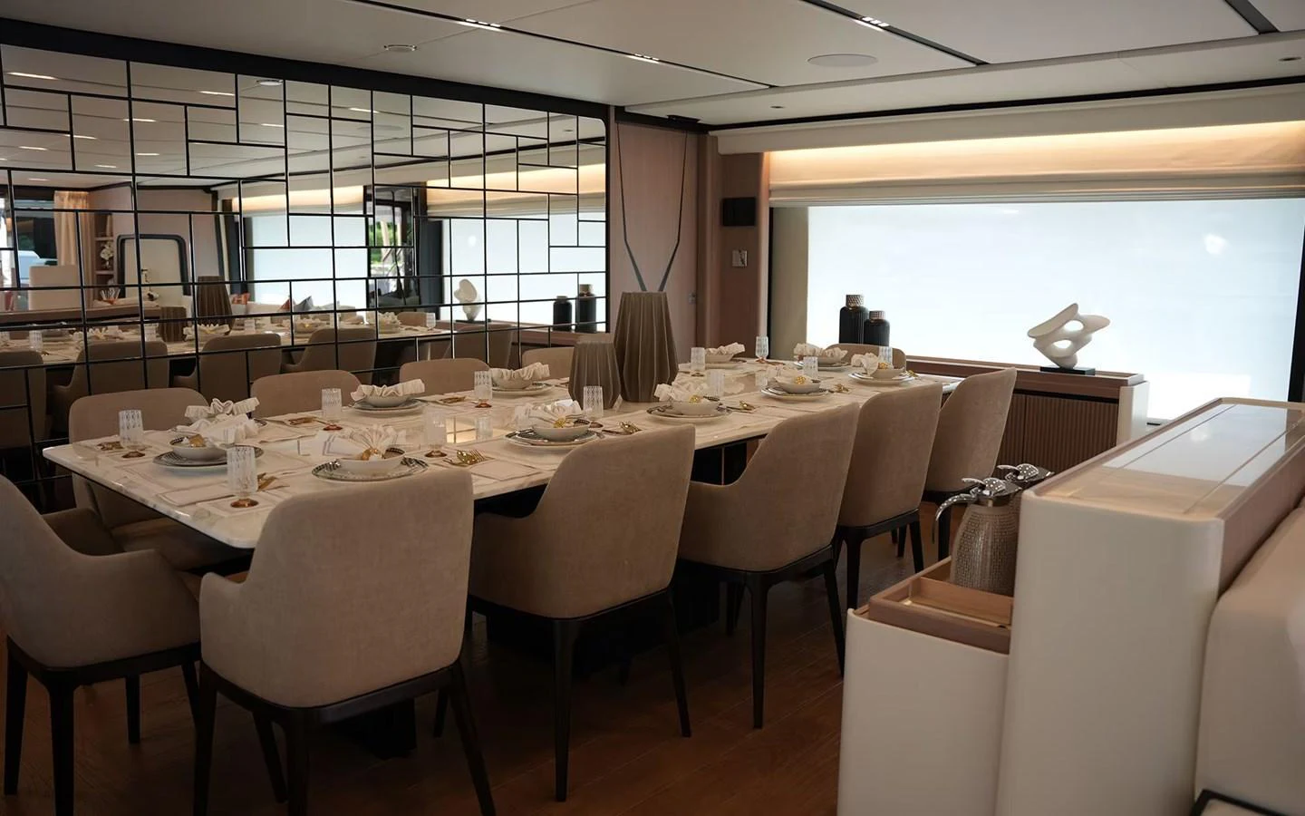 The yacht's dining area features a luxurious table setting with plush seating and elegant decor. aboard GEULUNEL Yacht for Sale