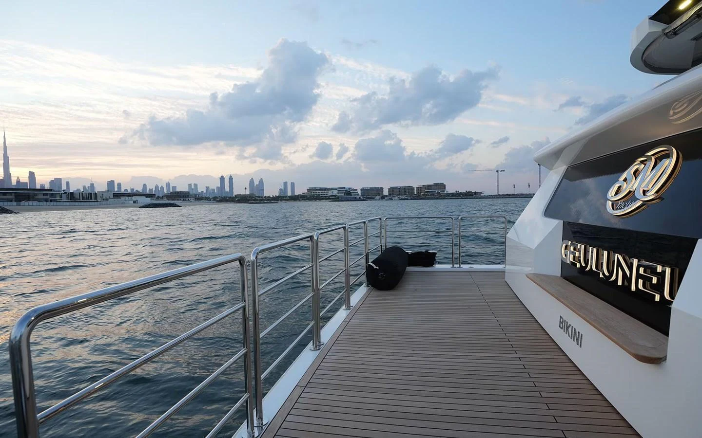The aft deck offers a serene view of the water and city skyline, perfect for relaxation. aboard GEULUNEL Yacht for Sale