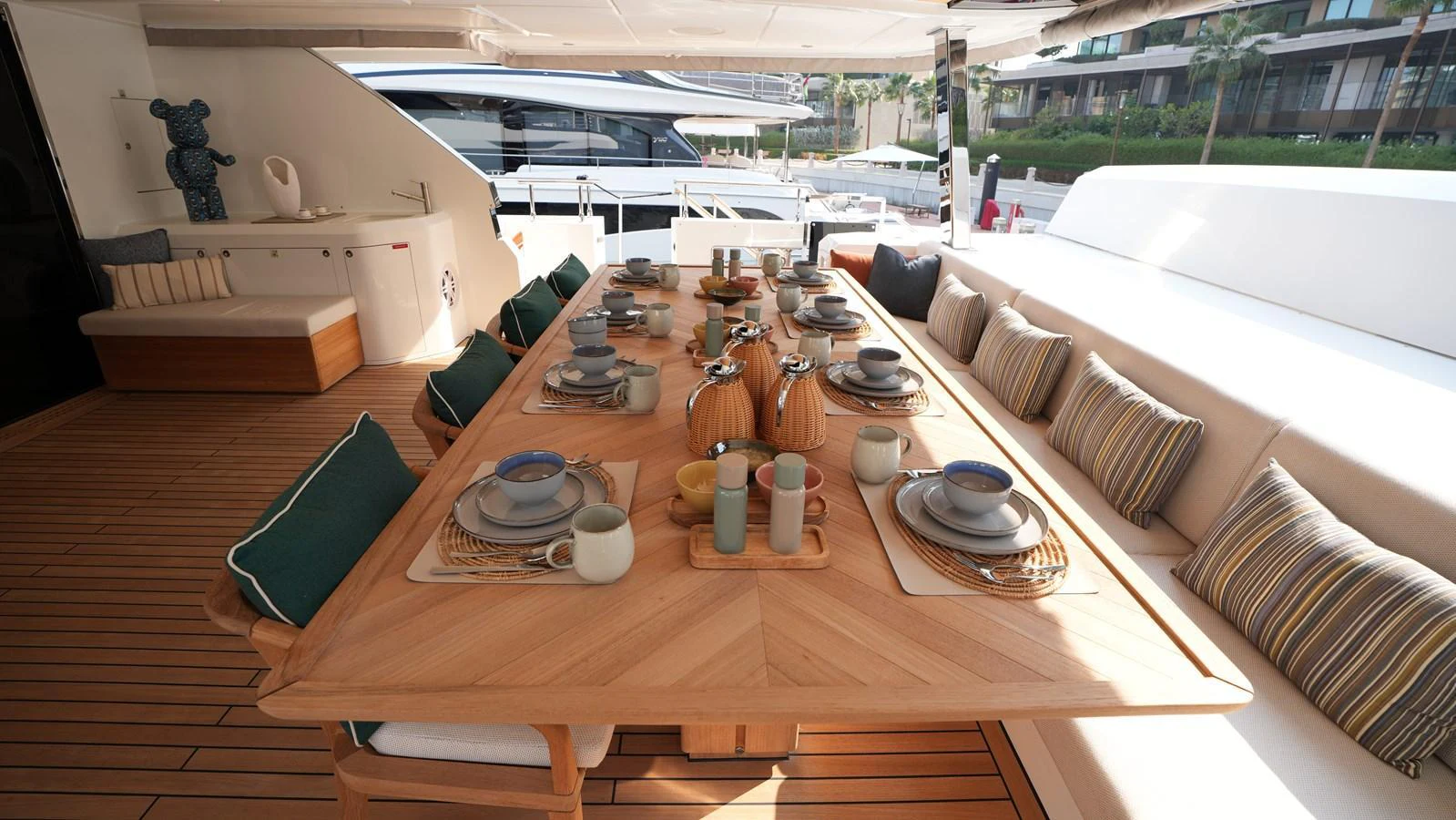 The aft deck features a spacious dining area with elegant table settings, perfect for alfresco meals. aboard GEULUNEL Yacht for Sale