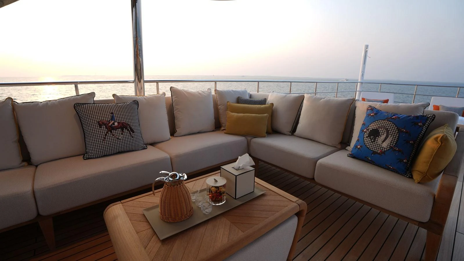 The aft deck features a cozy seating area with plush cushions and a beautiful ocean view. aboard GEULUNEL Yacht for Sale