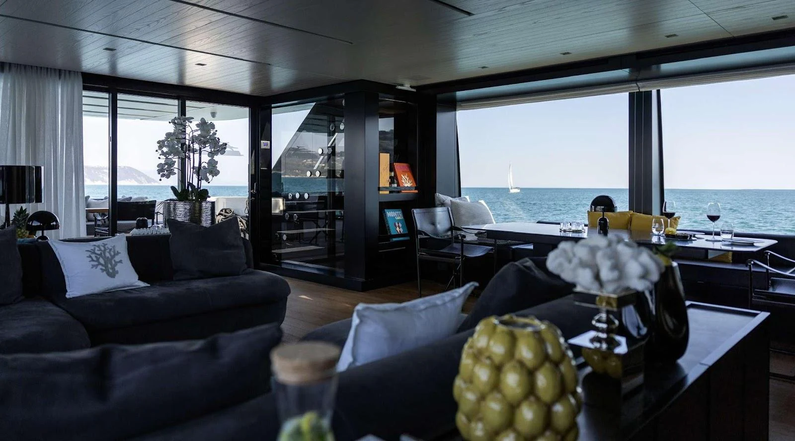 The yacht's interior features a spacious and modern living area with large windows offering stunning ocean views. aboard SOLEDO Yacht for Sale