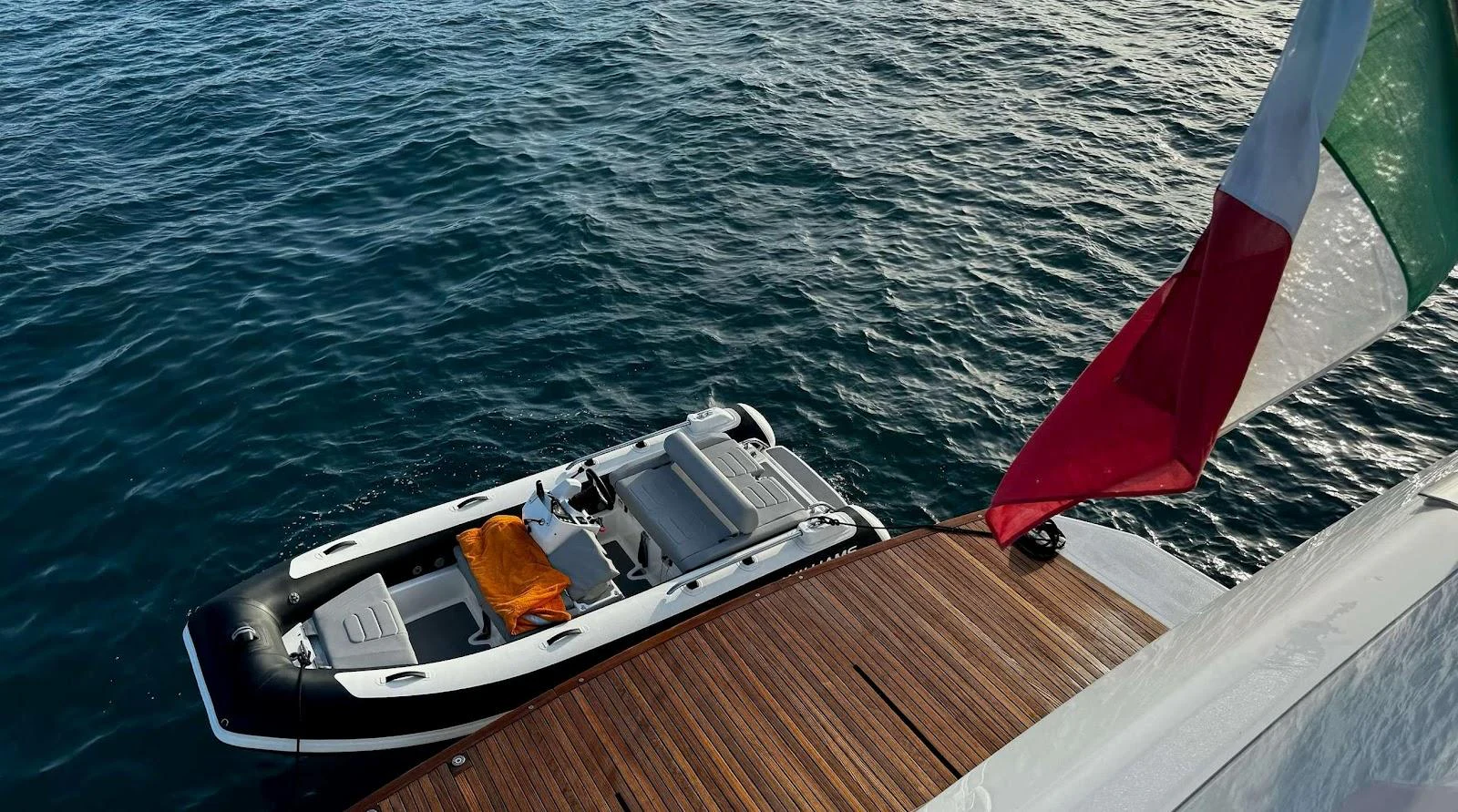 A sleek tender is docked beside the yacht, ready for excursions. aboard SOLEDO Yacht for Sale