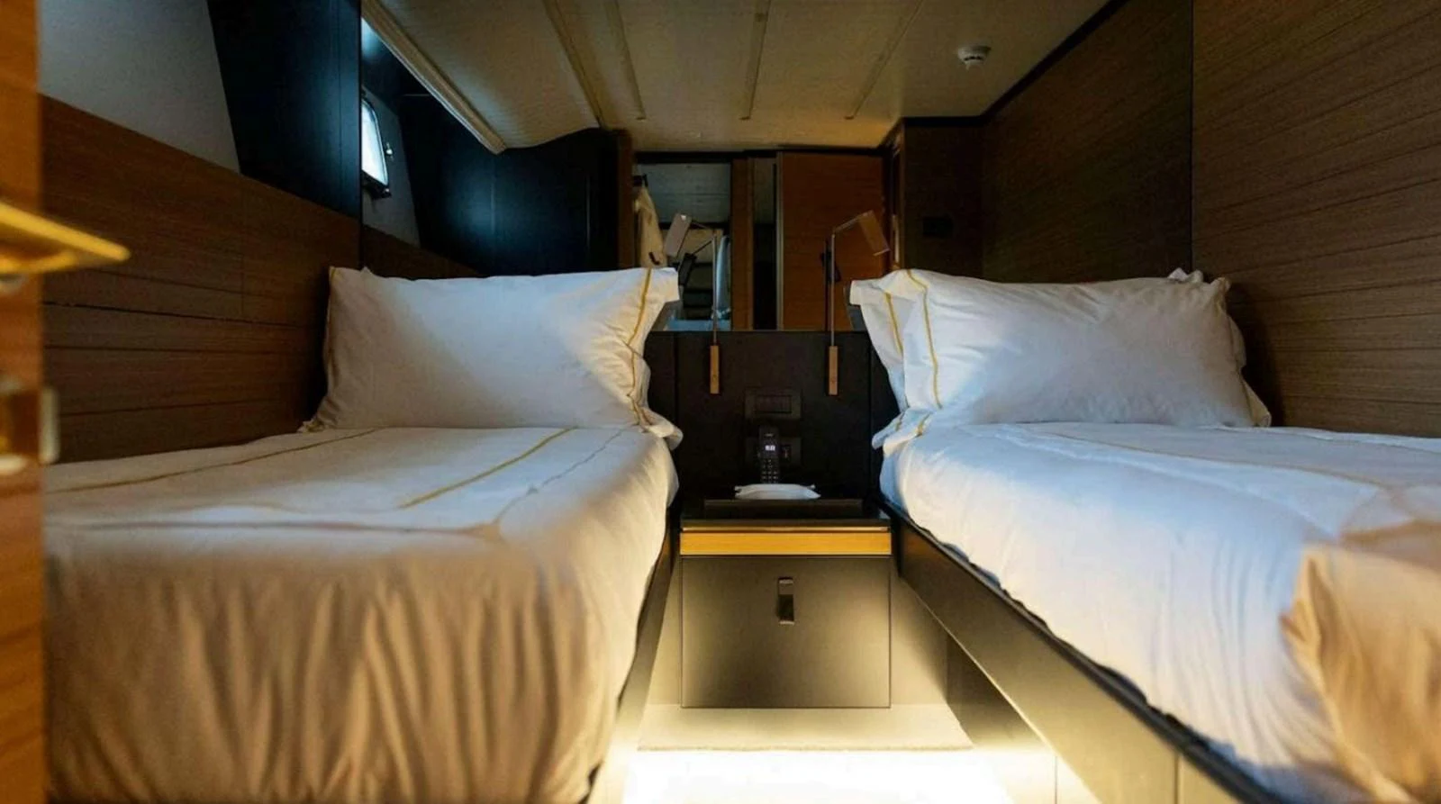 The twin stateroom offers a cozy and comfortable sleeping arrangement with two single beds and modern decor. aboard SOLEDO Yacht for Sale