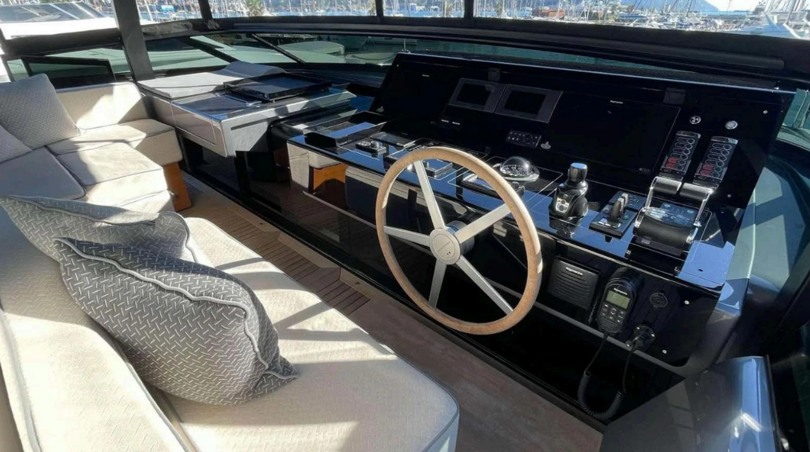 The helm station features a sleek, modern design with advanced navigation equipment and comfortable seating. aboard SOLEDO Yacht for Sale