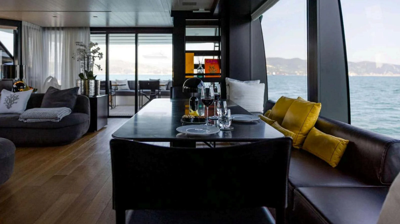 The yacht's salon offers a luxurious and comfortable space with large windows providing stunning ocean views. aboard SOLEDO Yacht for Sale