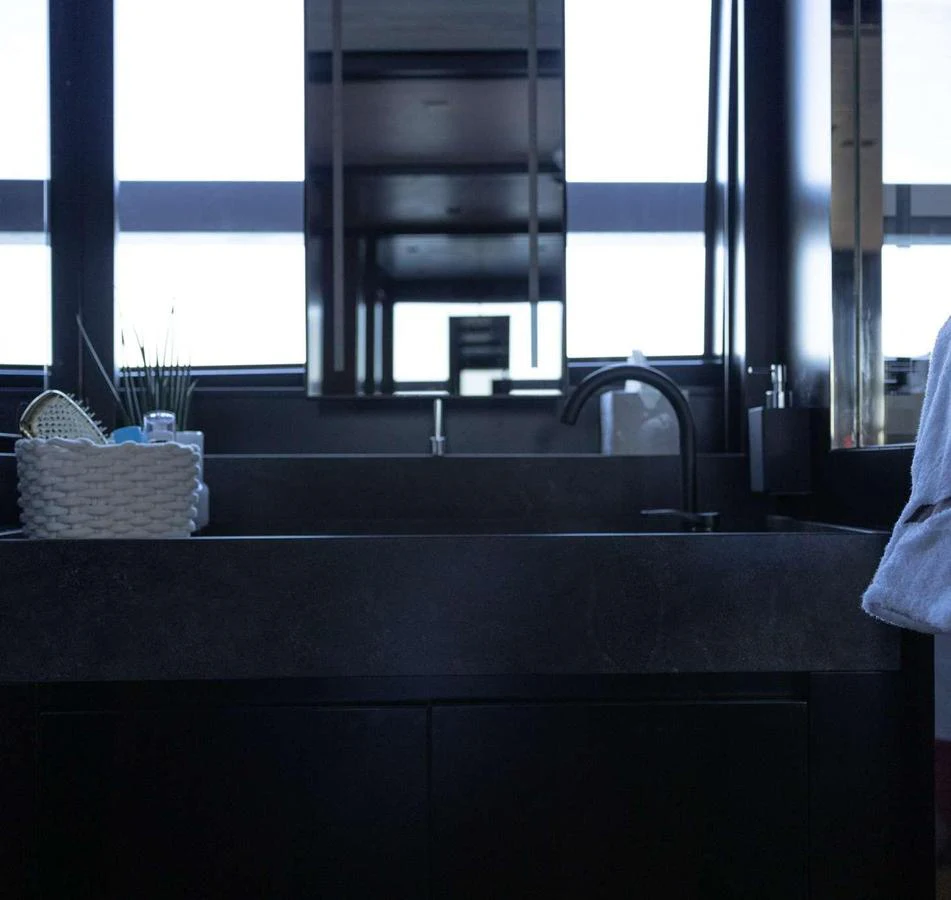 A modern yacht bathroom with sleek fixtures and a minimalist design. aboard SOLEDO Yacht for Sale